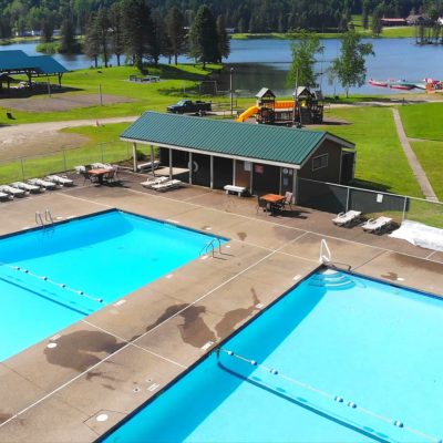An aerial view of a swimming pool near Rainbow Lake at a campground.