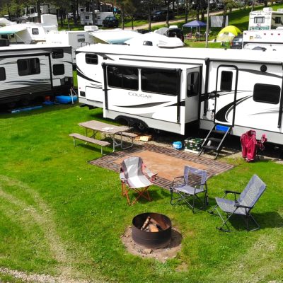 A group of RVs parked in a grassy campground area in WNY.
